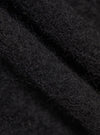 Close-up of the Black Wool Fleece Zip Waistcoat. The image shows the texture of the black wool fleece material.