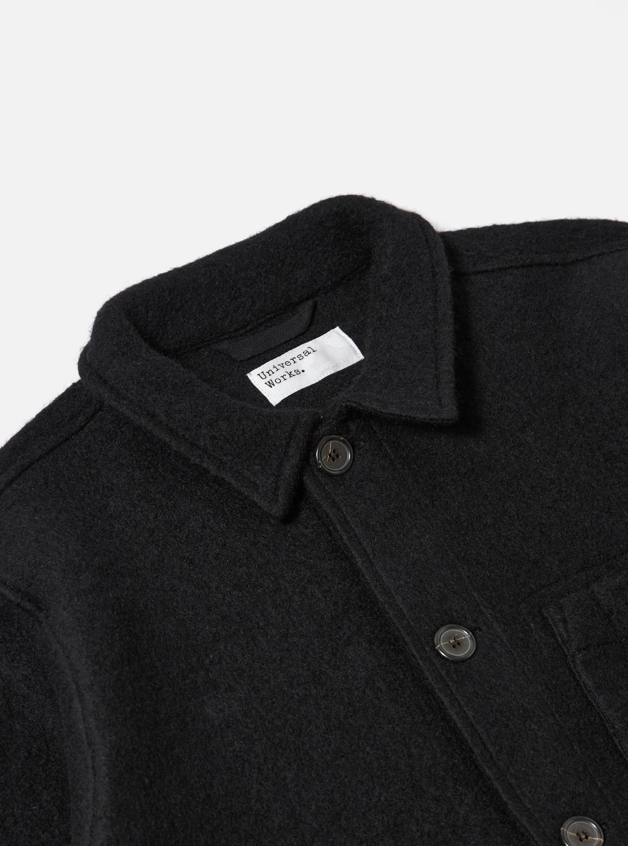 Close-up of the Black Wool Fleece Field Jacket on a white background. The jacket features a button-up design and a classic collar.