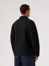 Back view of a man wearing a Black Wool Fleece Field Jacket. The jacket is on a white background and the model is wearing blue pants.