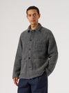 A man poses in a Grey Marl Wool Fleece Field Jacket against a white background. The jacket has a relaxed fit and visible pockets.