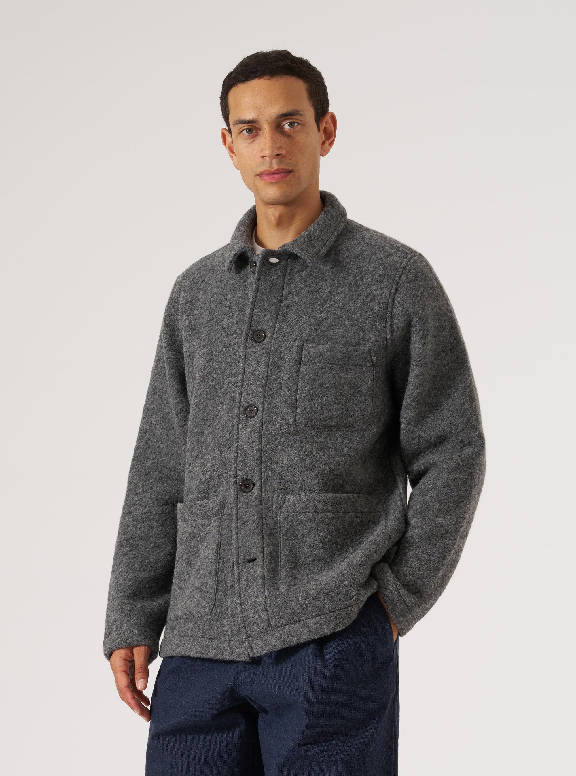 A man poses in a Grey Marl Wool Fleece Field Jacket against a white background. The jacket has a relaxed fit and visible pockets.