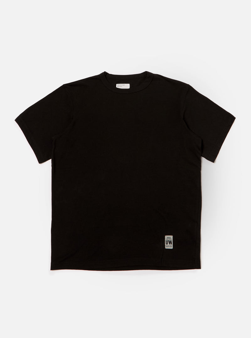 The Black Single Jersey Core Tee is displayed on a white background. The tee is a solid black color and has a relaxed fit.