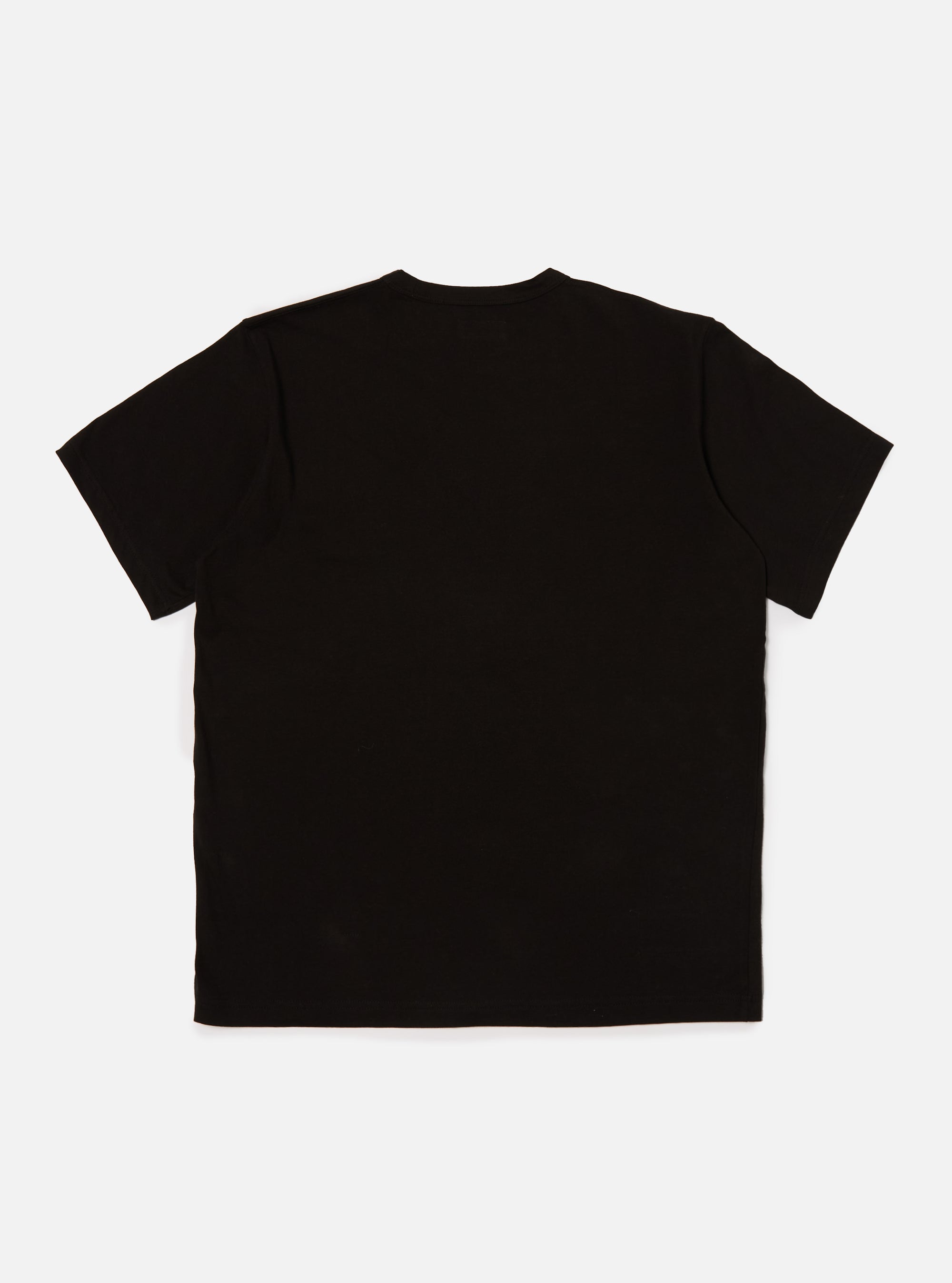 Back view of a Black Single Jersey Core Tee, a simple black t-shirt, laid flat on a light gray background.
