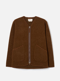 Cacao brown wool fleece zip liner jacket laid flat on a light grey studio backdrop. Collarless V-neckline with tonal bound edging, full-length silver metal zip, and two patch pockets at the lower front. Textured boiled wool fleece fabric throughout. Universal Works woven label visible at the neck.