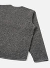 Grey marl wool fleece zip liner jacket, flat lay on a white studio backdrop. Shot shows the back and right sleeve at close range. The boiled wool fleece texture is visible across the body and sleeve. A contrast bound hem runs along the bottom edge. The round neckline is partially visible at the top.