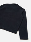 Flat lay of a navy wool fleece uniform jacket shot from above at an angle on a white surface. The back and one sleeve are visible, showing the boiled wool texture, a clean ribbed hem, and a small collar visible at the top. The sleeve tapers to a plain cuff.