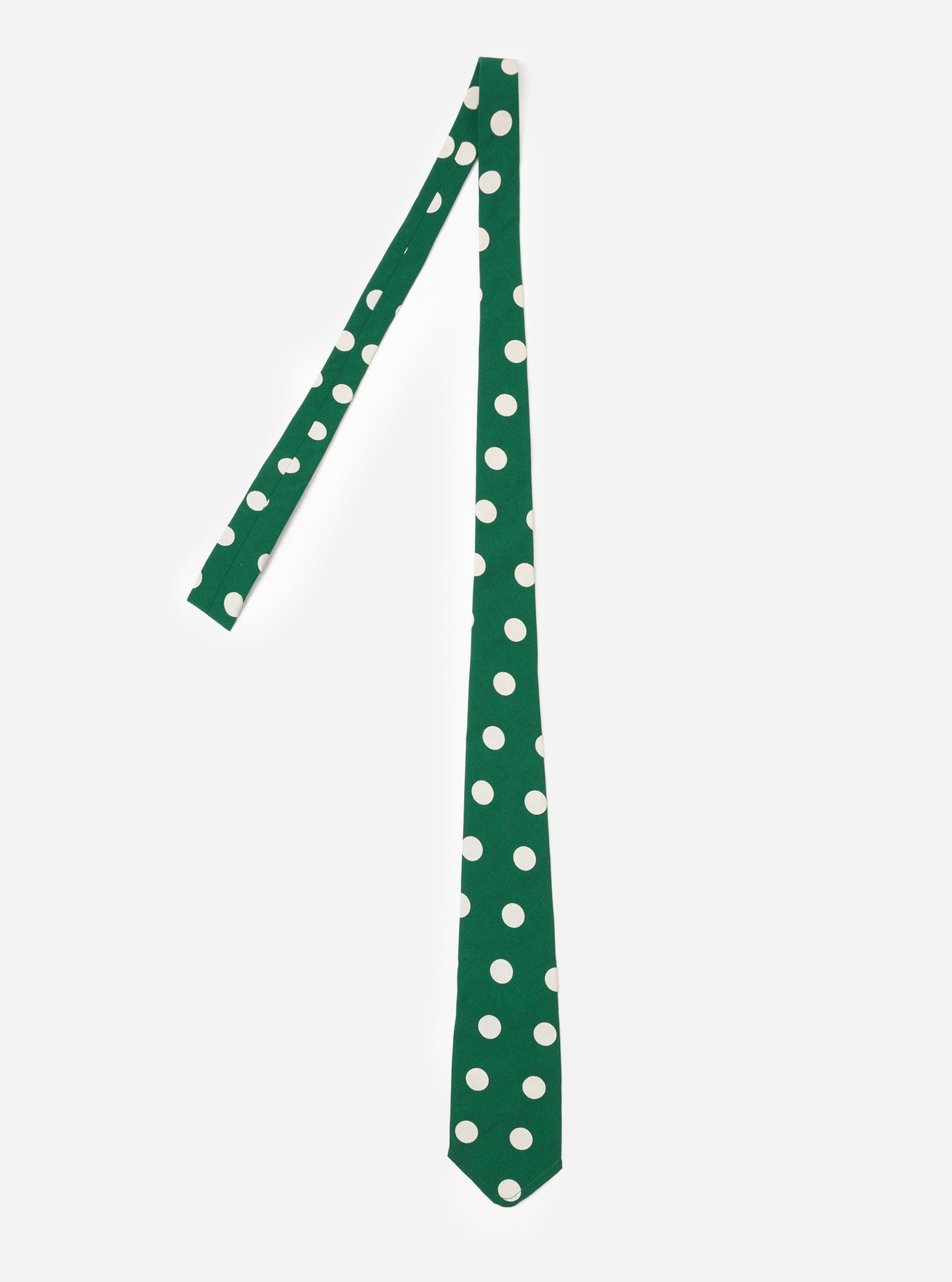 The Forest Green Bold Dot Print Rayon Tie is shown as a flat lay against a plain white background. The tie features a deep forest green base color with an all-over print of large, off-center white dots. The fabric has a smooth, slightly lustrous appearance characteristic of rayon.