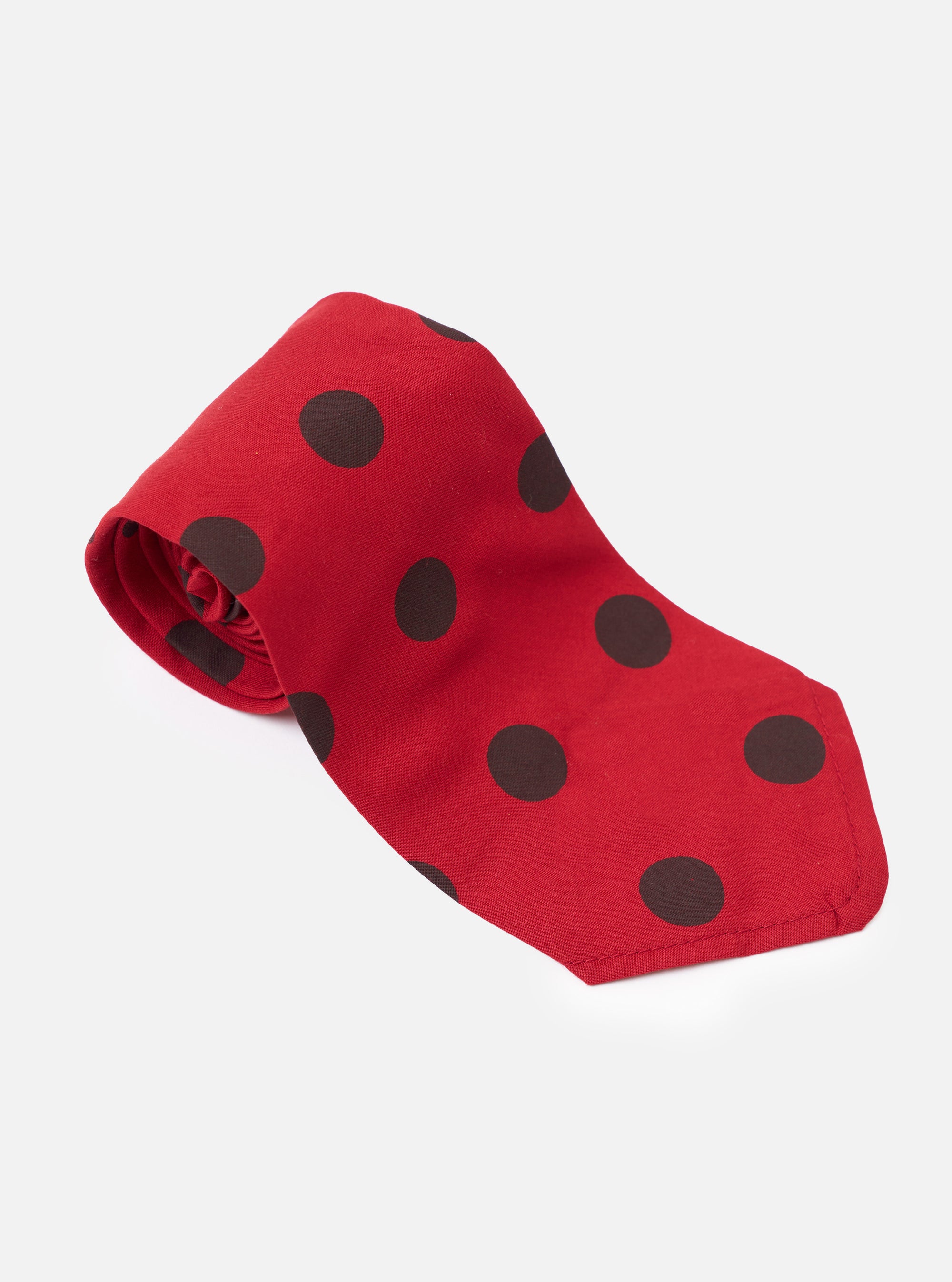 The Red/Black Bold Dot Print Rayon Tie is shown from a rear angle as a flat lay against a plain white background. The image highlights the reverse side of the tie, showcasing the keeper loop and the red and black bold dot pattern.
