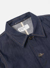 Close-up of the Indigo 13oz Selvedge Denim Bakers Jacket on a white background. Shows the jacket's collar, buttons, and stitching details.