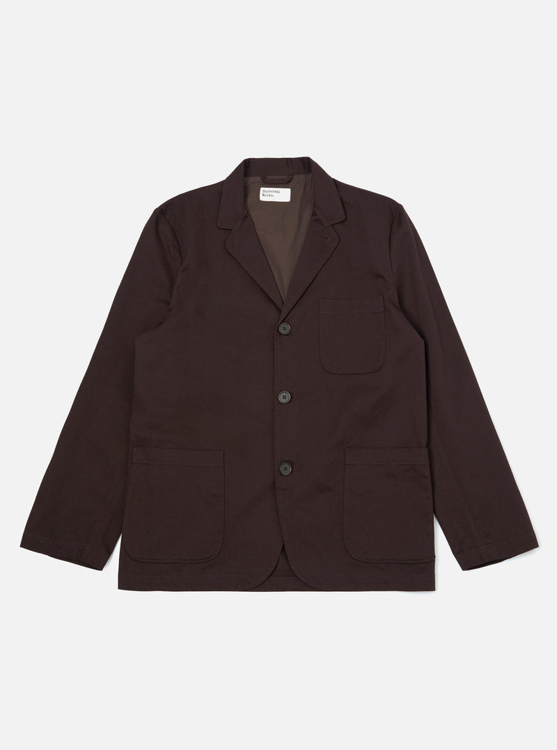 A Brown Twill Three Button Jacket is displayed laid flat against a plain white background. The jacket features a three-button front closure, a notched lapel, and three patch pockets on the front.