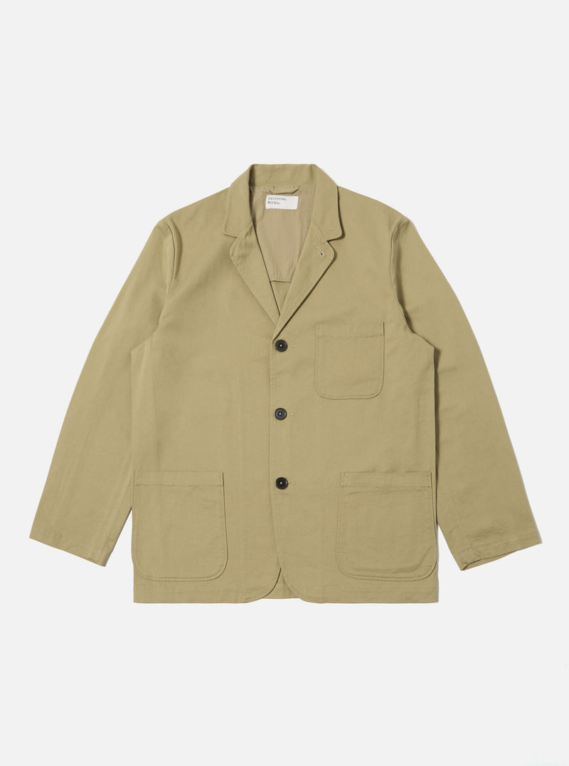 The Sand Twill Three Button Jacket is laid flat on a white background. The jacket is a light tan color and made of twill. It has three dark buttons and two large pockets.