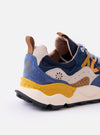 The Flower Mountain Navy/Light Navy Suede/Nylon Yamano 3 Man is shown from a side profile view against a plain white background. The sneaker features a dark navy technical fabric upper with light navy suede overlays, a multi-colored tape and lace system with orange trekking laces, and a signature chunky cream rubber sole with an indented tread. A natural cork insole is visible at the heel, and a webbing pull tab is attached to the back.