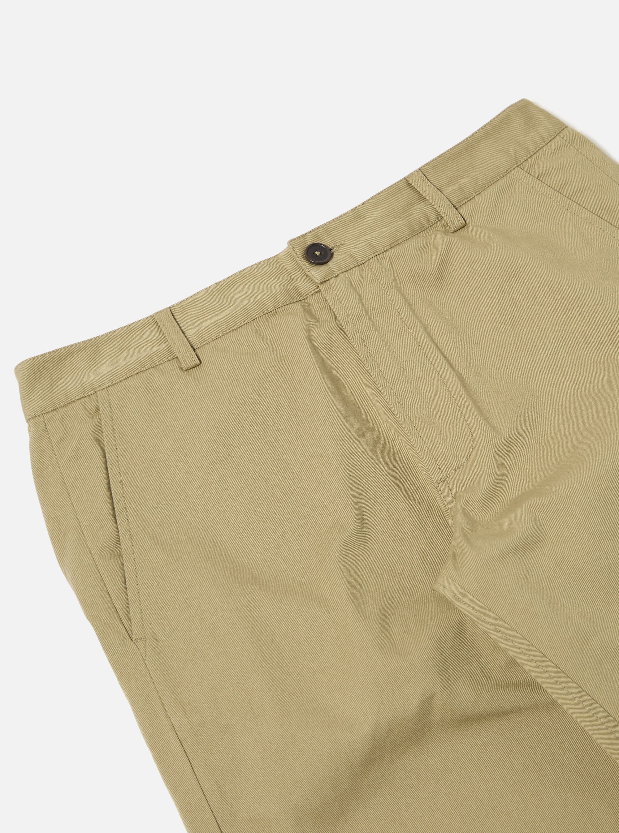 Close-up of the Sand Twill Aston Pant on a white background. The twill fabric is a light tan color. Details include the button, belt loops, and pocket.
