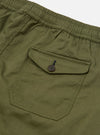 The Light Olive Twill Beach Short is shown from the back in a studio shot against a white background. The image highlights the single rear patch pocket with a visible eyelet and the elasticated waistband. The shorts are displayed as a flat lay with no model or mannequin present.