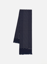 Close-up of a Navy Dot Print Short Scarf on a white surface. The scarf is navy with small white dots and has a fringed edge.