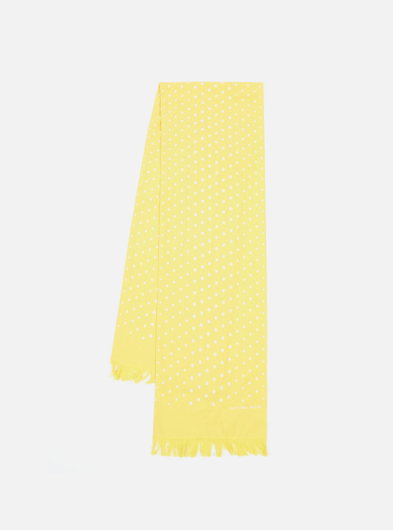 Studio shot of a Yellow Dot Print Short Scarf on a white background. The scarf is light yellow with white polka dots and fringed edges.