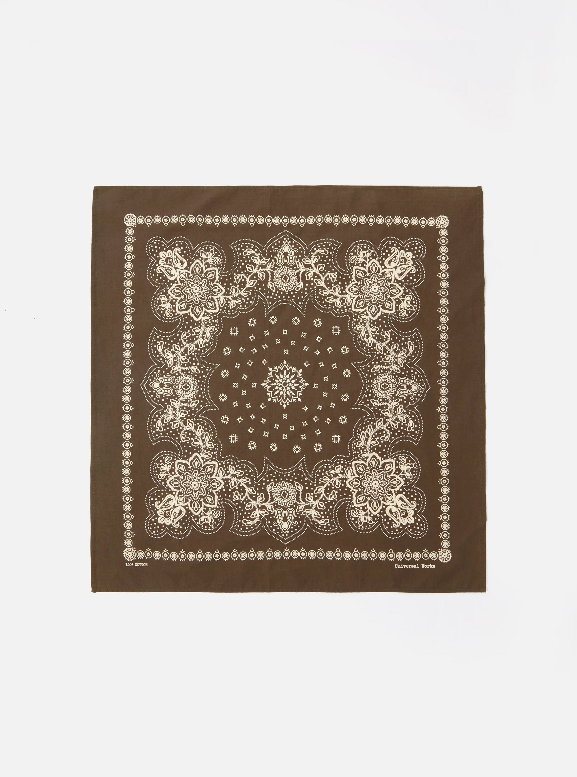 Flat lay of an Olive Classic Bandana Neckerchief on a white background. The bandana is brown with a white floral paisley print and border.