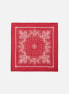 The Red Classic Bandana Neckerchief, a square of red cotton with a white paisley pattern, is displayed on a white background.