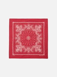 The Red Classic Bandana Neckerchief, a square of red cotton with a white paisley pattern, is displayed on a white background.