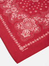 Close-up of a red 100% cotton Red Classic Bandana Neckerchief with a white paisley pattern on a white surface.