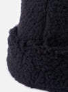 Close-up of the cableami® Black Toque Boa Cap, showcasing its soft, textured material against a clean white background. The image highlights the hat's cozy and stylish design.