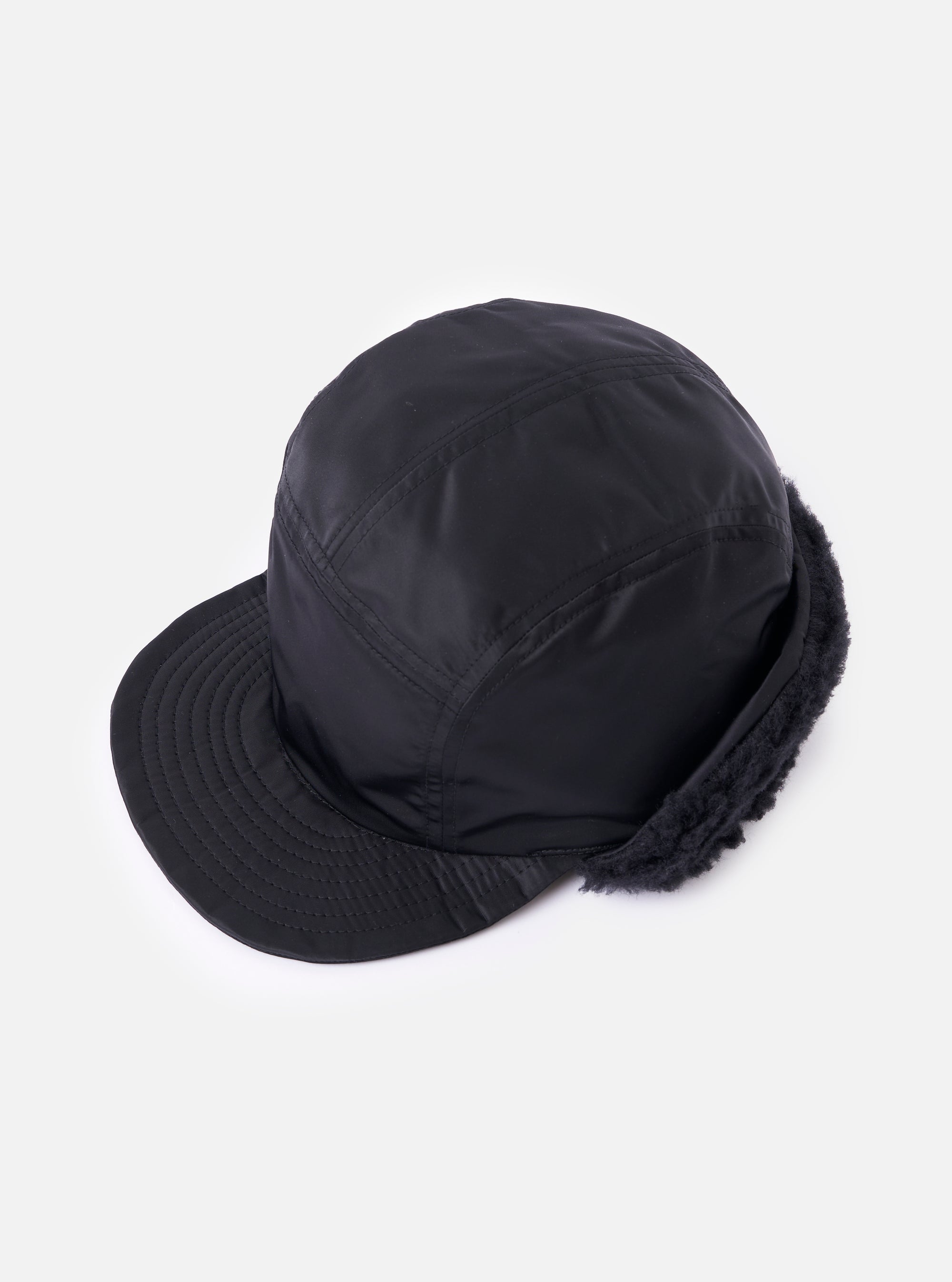 cableami® Black Military Nylon Twill Cap on a white background. The cap is black nylon with a short brim and ear flaps lined with black faux fur.