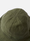 The cableami Dark Olive Baker Back Satin Cotton Metro Hat is shown from a side angle against a plain white background. The six-panel bucket hat features a downward-sloping brim, tonal topstitching, and a visible adjustable drawcord with a plastic toggle. The fabric has a matte, slightly textured back-satin finish in a dark olive green.