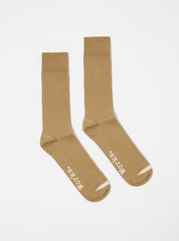 Studio shot of Cumin Rib Knit Modal Sock. Ribbed texture, cumin color. White logo detail. On a white background.