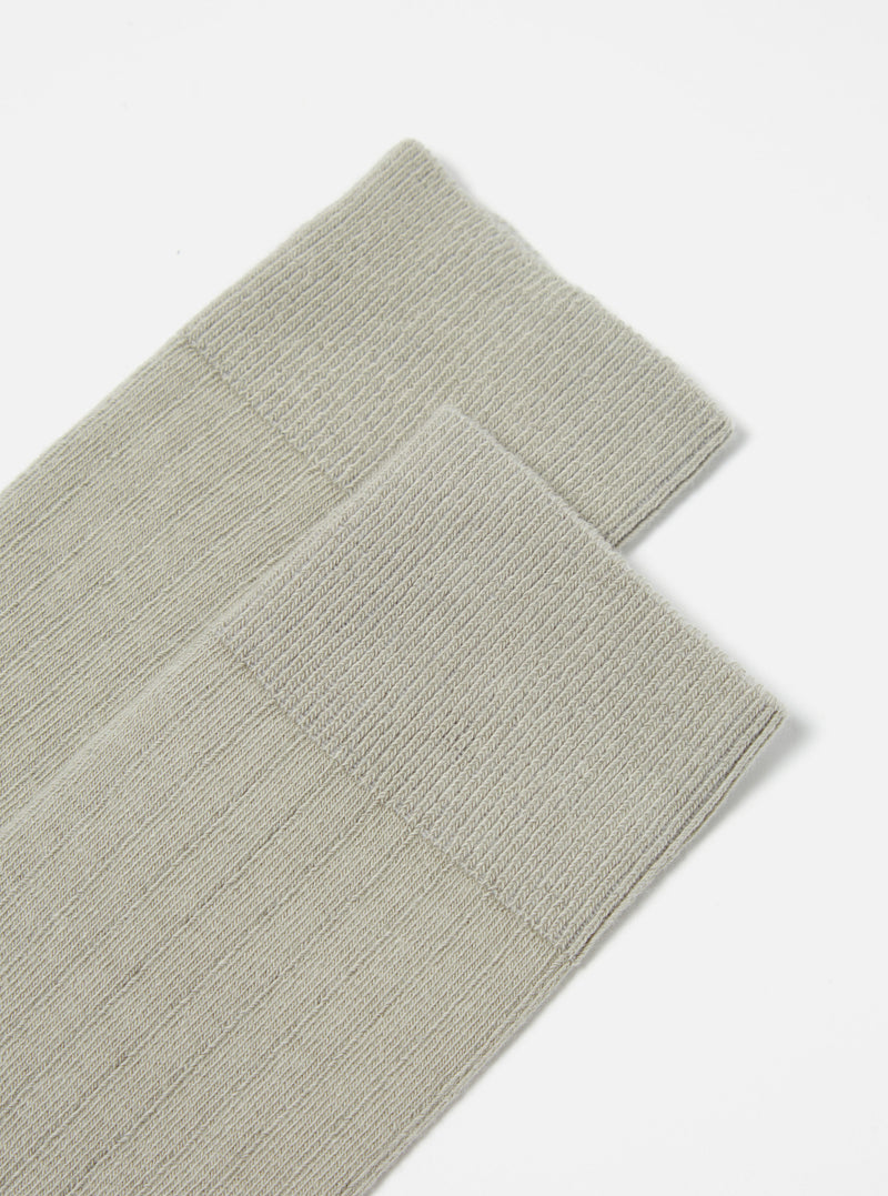Close-up of a pair of Grey Rib Knit Modal Sock on a white surface. The socks are neatly stacked, showcasing the ribbed texture.