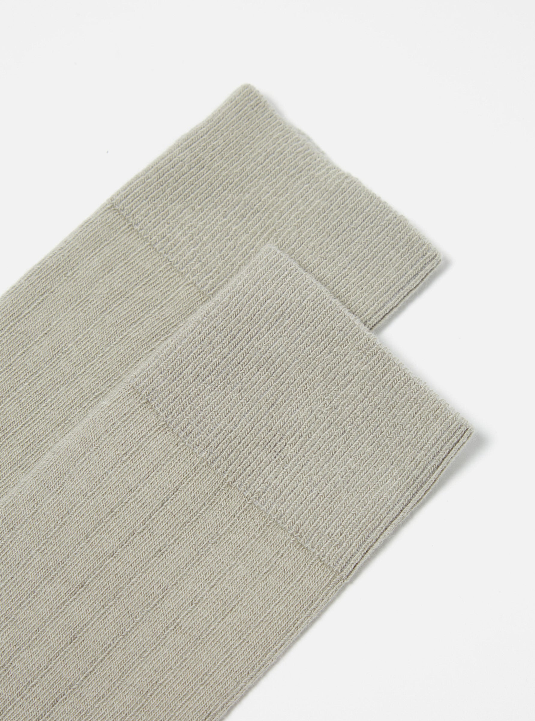 Close-up of a pair of Grey Rib Knit Modal Sock on a white surface. The socks are neatly stacked, showcasing the ribbed texture.