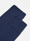 Close-up of a pair of Navy Rib Knit Modal Sock on a white surface. The socks are neatly stacked, showcasing their soft, ribbed texture and rich navy color.