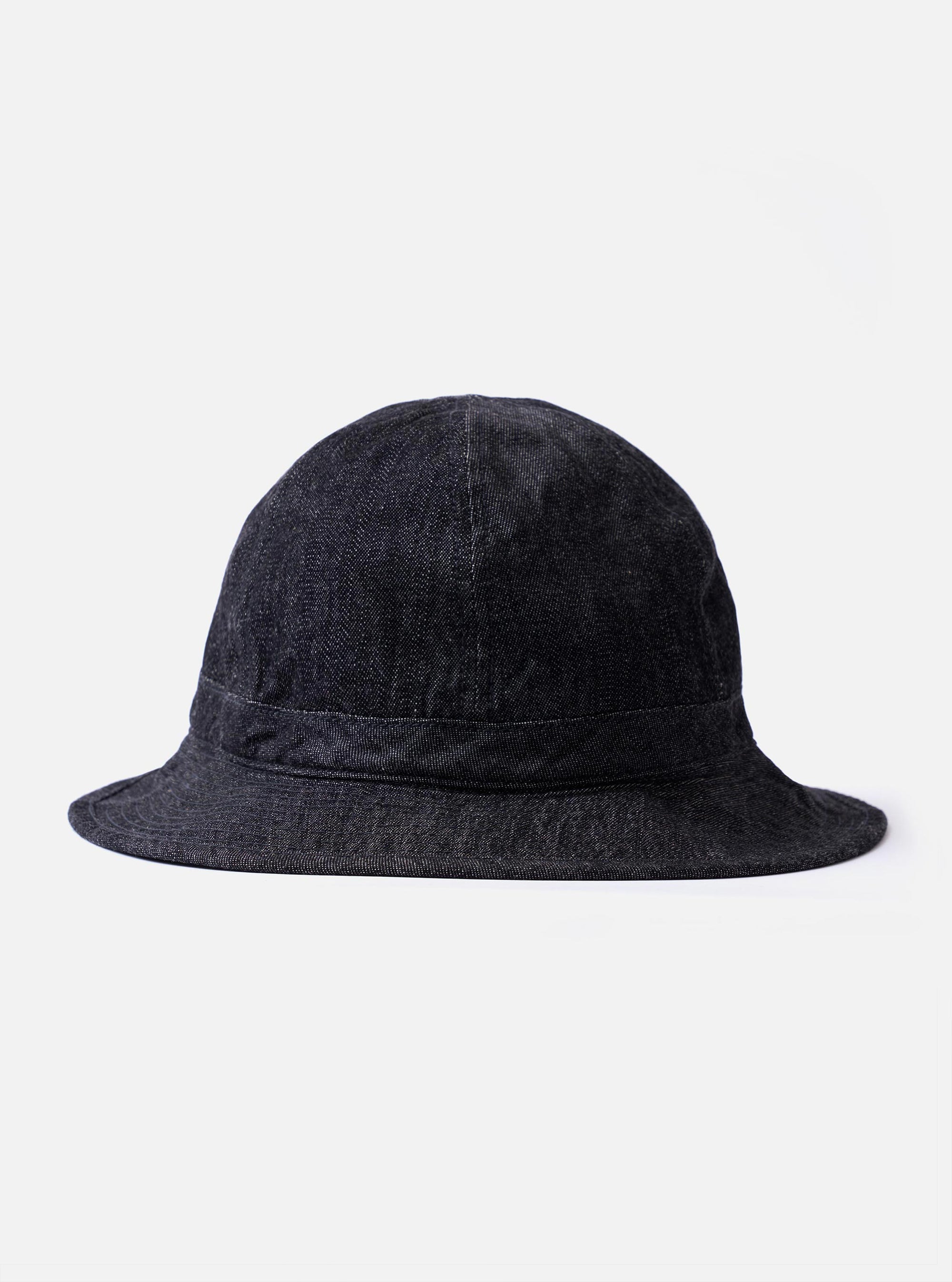 The cableami Black 10oz Denim Metro Hat is displayed as a flat lay against a plain white background. This black cotton denim hat features a wide, stitched brim, a rounded crown, and a detachable cord strap with an adjustable toggle.