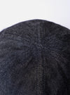 The cableami Black 10oz Denim Metro Hat is shown from a rear three-quarter angle as a flat lay against a plain white background. The image highlights the hat's rounded crown construction and the downward-sloping brim. The black denim fabric features visible tonal stitching throughout.