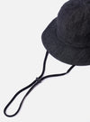 The cableami Black 10oz Denim Metro Hat is shown from a rear three-quarter angle as a flat lay against a plain white background. The image highlights the hat's rounded crown, the downward-sloping brim with tonal stitching, and the adjustable black strap cord with a toggle. The 10oz black denim fabric shows a subtle textured grain.