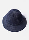 The cableami Indigo 10oz Denim Metro Hat is shown from a rear three-quarter angle as a flat lay against a plain white background. The image highlights the hat's rounded crown, downward-sloping brim with tonal stitching, and an adjustable strap cord featuring a plastic toggle.