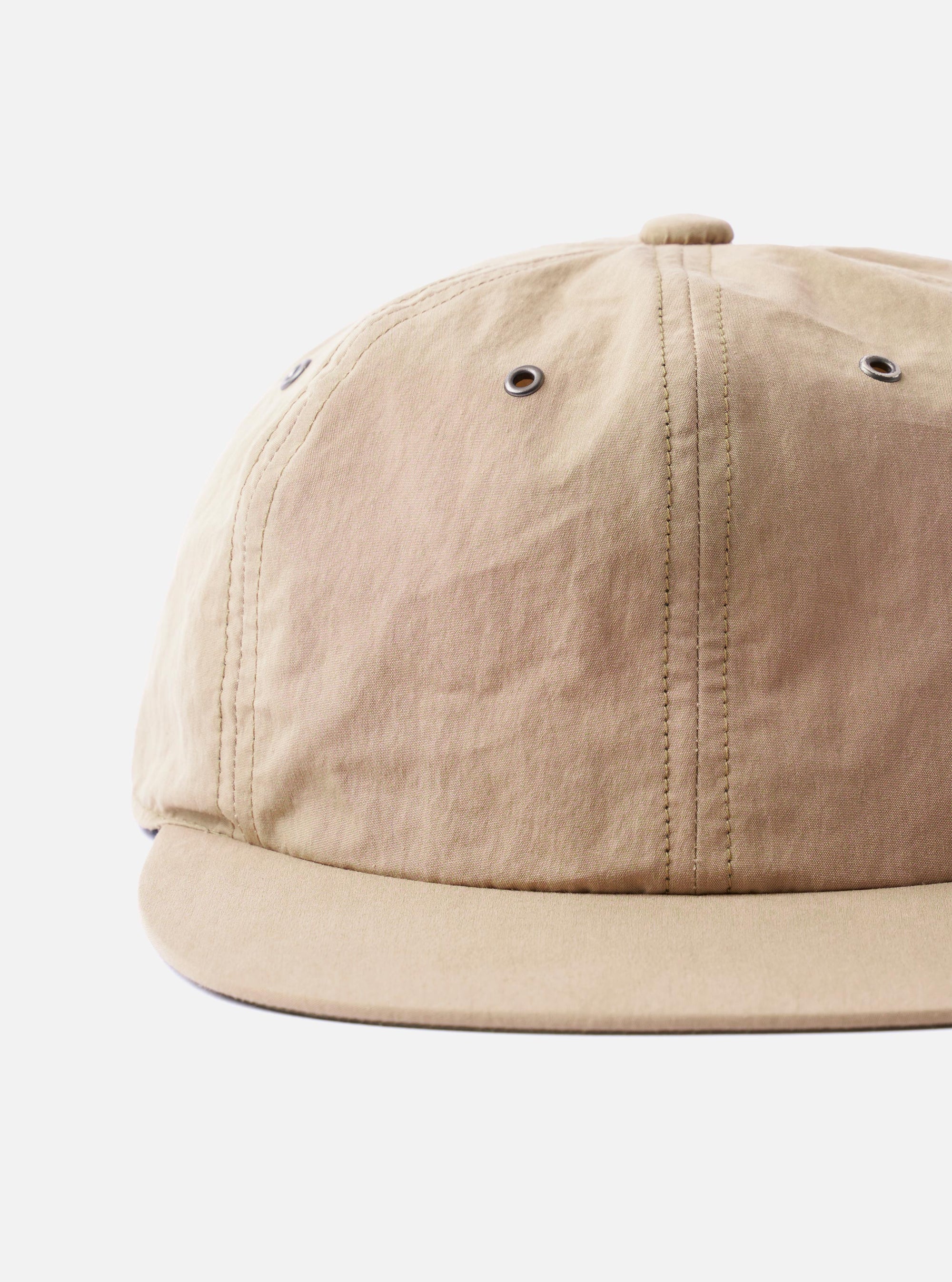 The cableami Beige/Olive Cotton/Nylon B.B Cap is shown from a rear angle as a flat lay against a plain white background. The image highlights the adjustable strap at the back and the panelled construction of the crown. The fabric is a smooth beige cotton-nylon blend with olive green detailing on the underside of the brim.