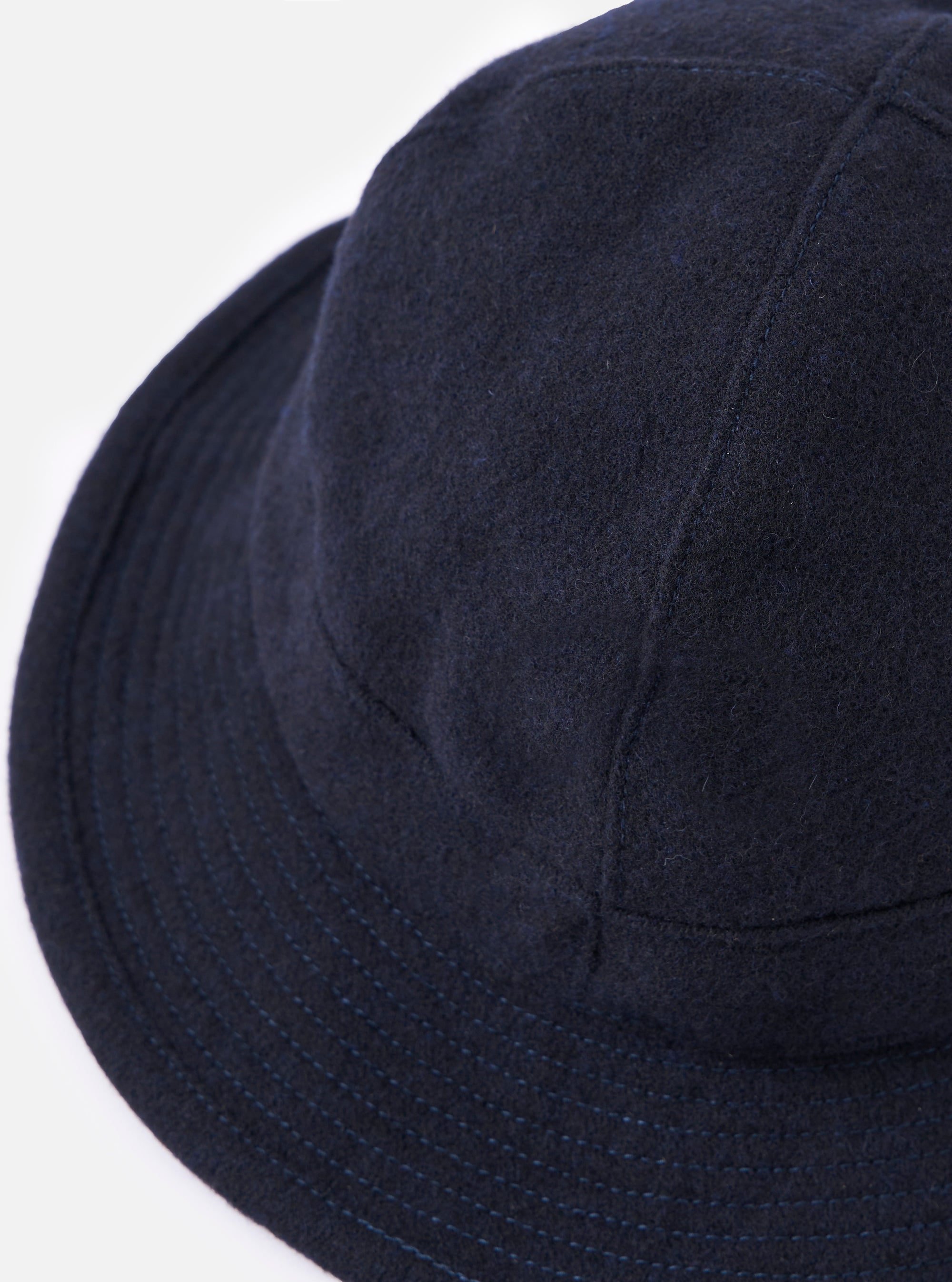 Close-up of the cableami® Navy Recycled Wool Army Hat on a white background. The hat is a deep navy color and made of recycled wool, with a classic army hat fit.