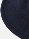 Close-up of the cableami® Navy Recycled Wool Army Hat. The hat is navy blue with subtle stitching, made of recycled wool. Shot on a white background.