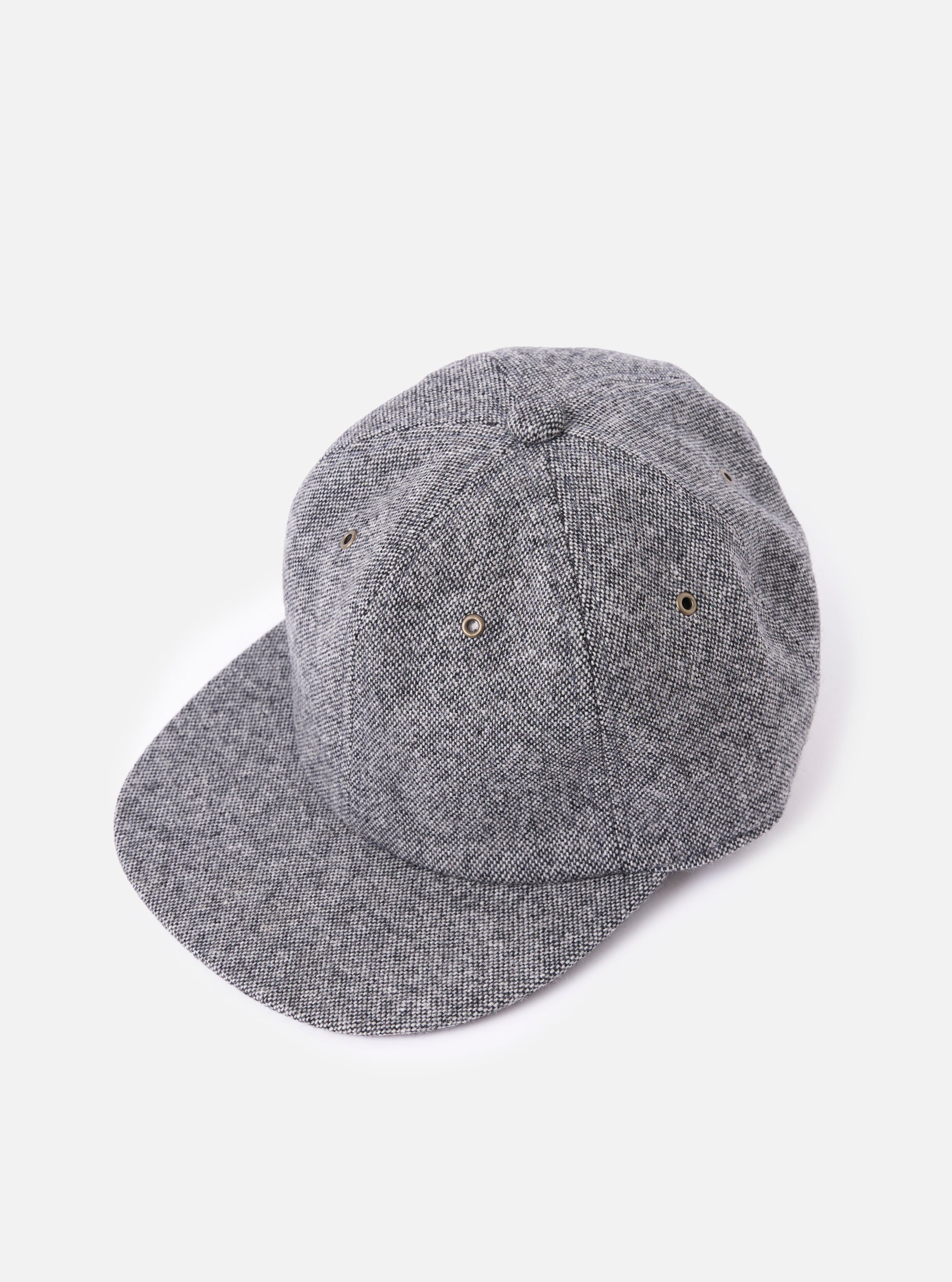 cableami® Black/White Recycled Tweed Cap on a white background. The cap is made of black and white tweed and has a classic fit.