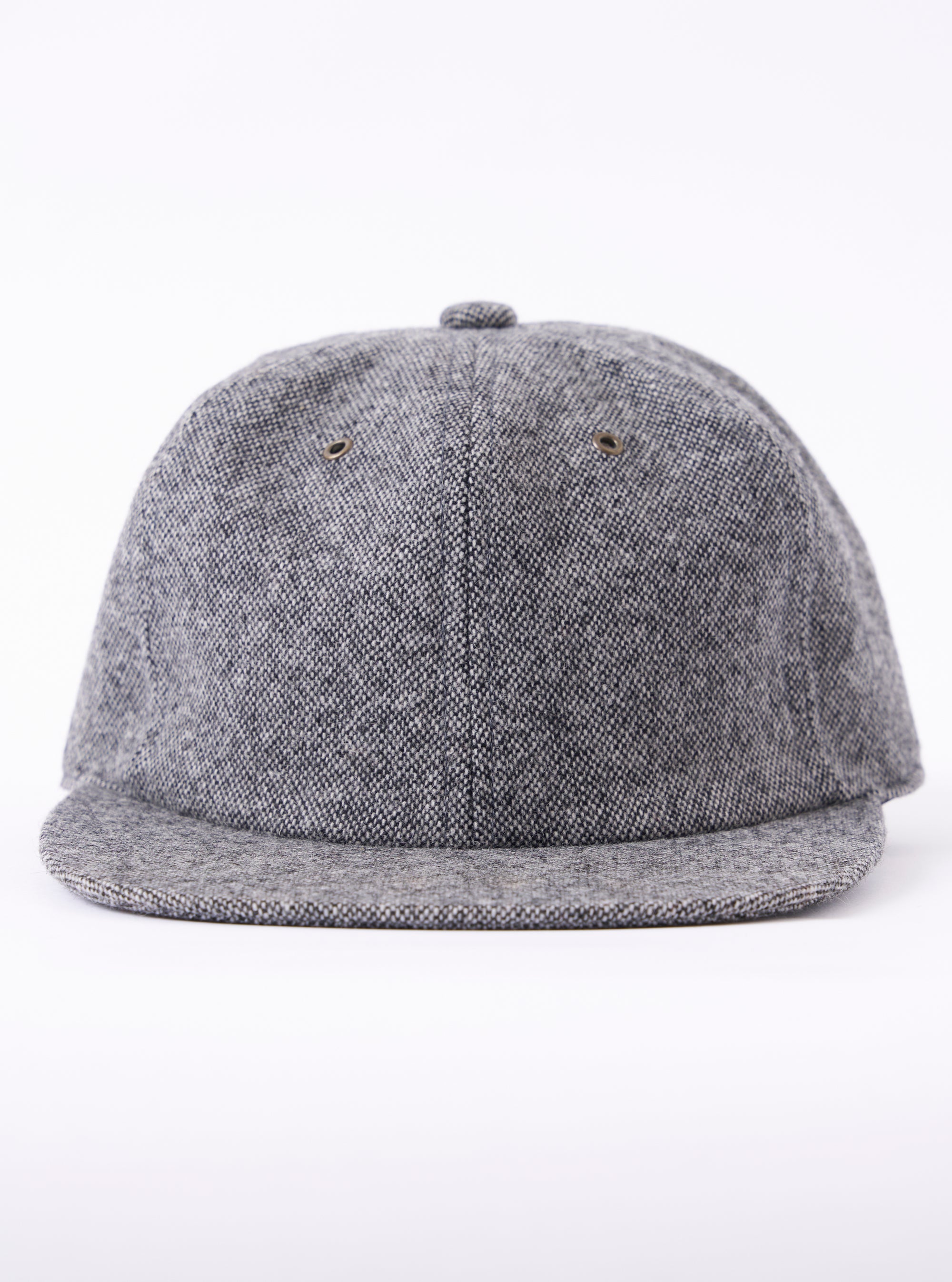 cableami® Black/White Recycled Tweed Cap on a white background. The cap is made of black and white tweed and has a classic fit.