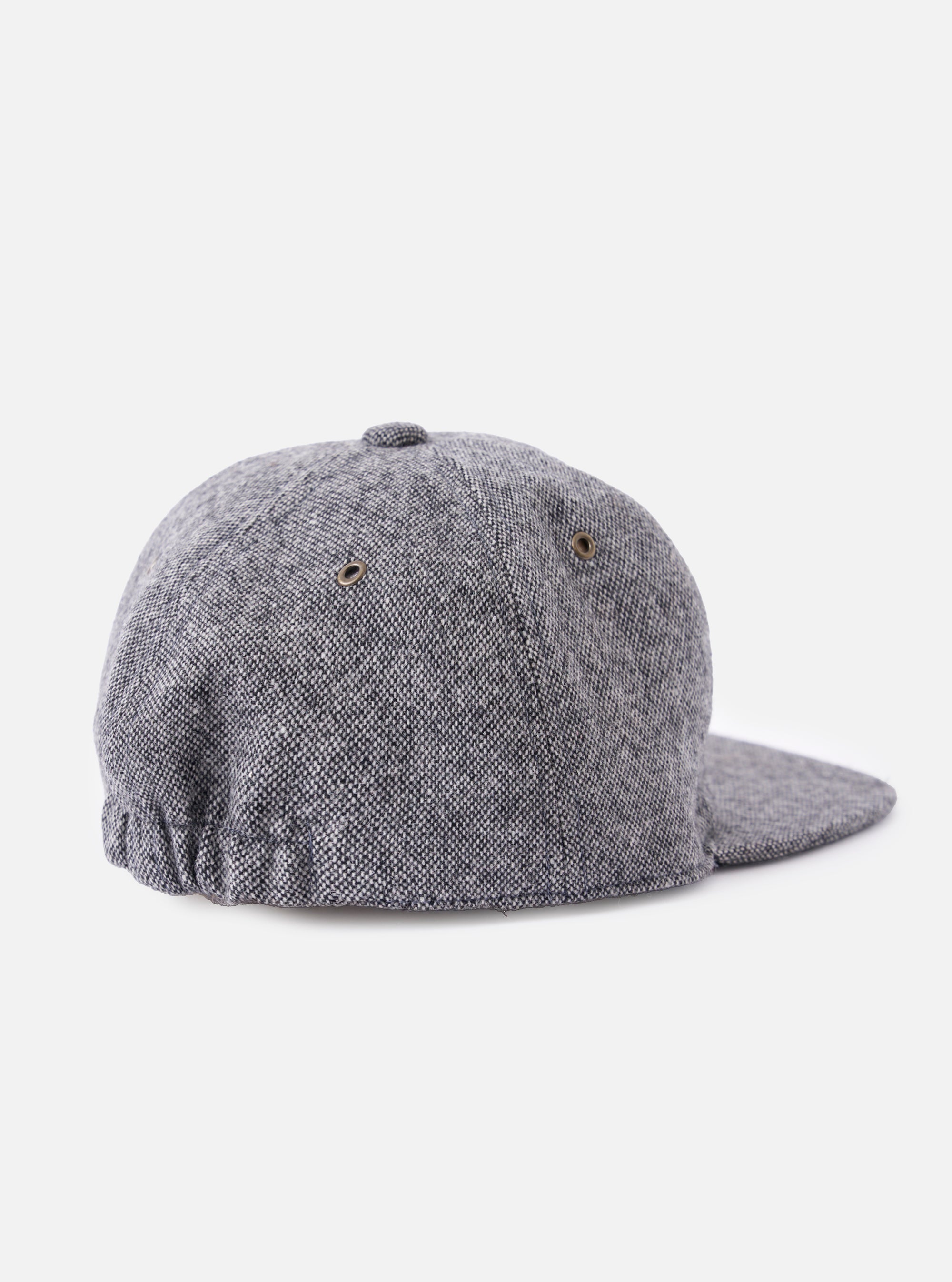 Back view of a cableami® Black/White Recycled Tweed Cap on a white background. The cap is made of black and white tweed and has a classic fit.