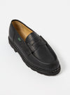 Studio shot of Paraboot Black Leather Reims Marche loafer. The shoe is black leather with a thick black sole. The background is white.