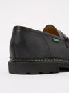 Close-up of a Paraboot Black Leather Reims Marche shoe on a white background. The black leather upper sits atop a thick black sole with a decorative welt.