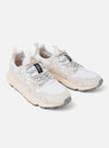 The Flower Mountain White/Off White Suede/Nylon Yamano 3 Uni is shown from a side angle against a plain white background. The sneaker features a layered upper of off-white suede and white technical nylon with unique perforated patterns. It is designed with trekking-style laces, leather eyelets, and a signature notched rubber sole.