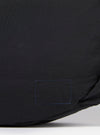 The master-piece x Universal Works Black Medium Canvas Shoulder Bag is shown from the back as a flat lay against a plain white background. The image highlights the clean construction of the black canvas bag, featuring a central vertical seam and the adjustable shoulder strap extending from the top corners.