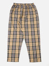 The Sand Tartan Check Pyjama Pant on a white background. The pants have a sand, gray, black, and red tartan pattern. The fit is loose and comfortable.
