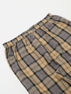 Close-up of the Sand Tartan Check Pyjama Pant on a white background. Features a sand, gray, black, and red tartan pattern with an elastic waistband.