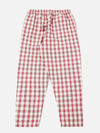 The red cotton check pyjama pant is laid flat on a white background. The relaxed-fit pants feature a red and white plaid pattern and an elastic waistband.