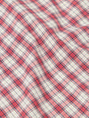 Close-up of the Red Cotton Check Pyjama Pant fabric. The red and blue plaid cotton is softly draped on a flat surface.