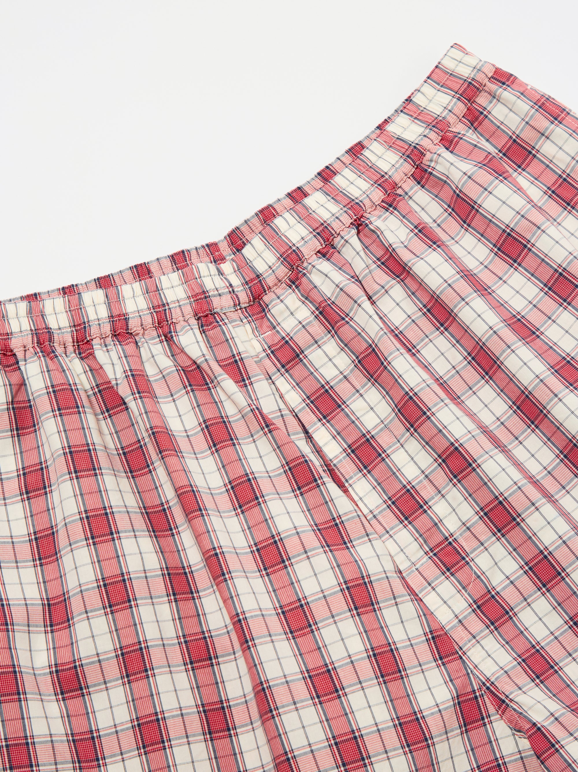 Close-up of the Red Cotton Check Pyjama Short on a white surface. The red and white plaid pattern is visible, showcasing the soft cotton material and comfortable fit.